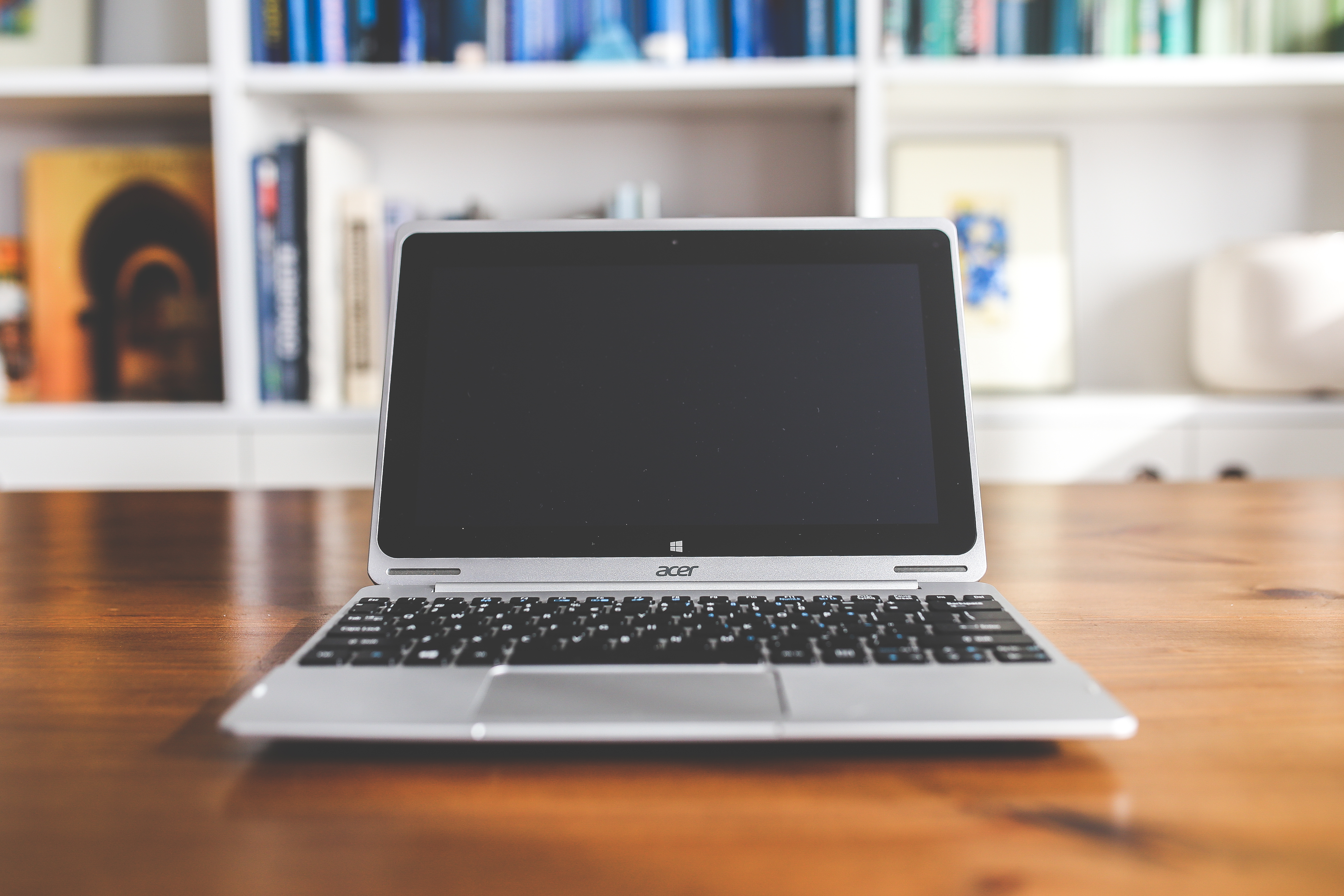 A desk setup with a laptop and notebook ready for focused work